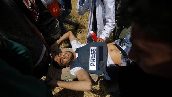 Yaser Murtaja, 30, was shot in the stomach in Khuza'a in the southern Gaza Strip on April 6 [Ibraheem Abu Mustafa/Reuters]