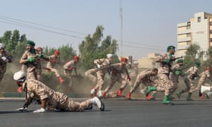 Iranian soldiers run for cover following the deadly attack on a parade in the south-west city of Ahvaz.